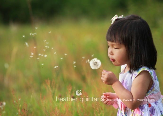 Girl blowing dandelion